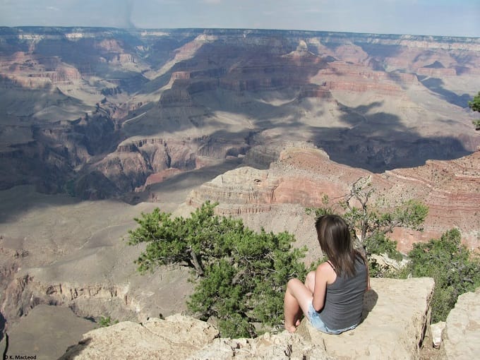 Sitting at the edge of the Grand Canyon