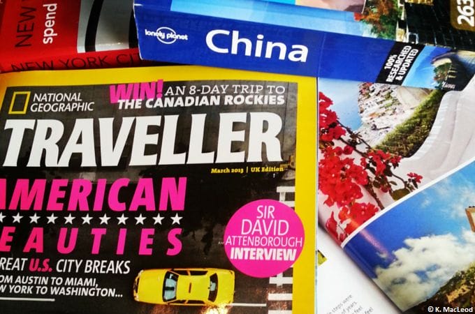 Travel magazines and guides on a table