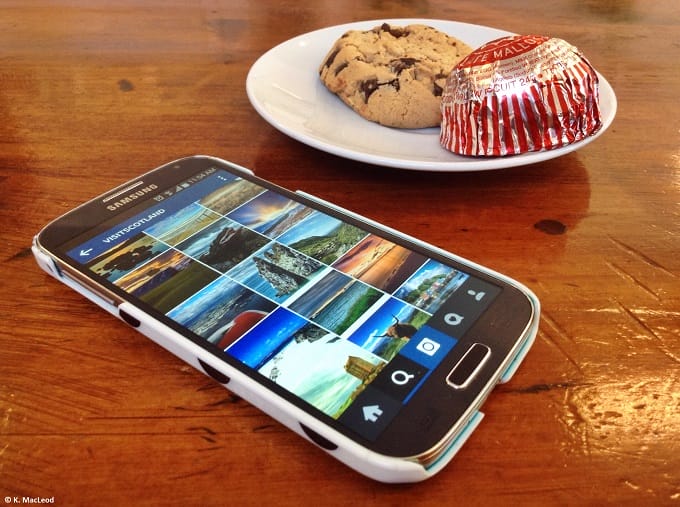 A smart phone and Tunnocks tea cake on a table