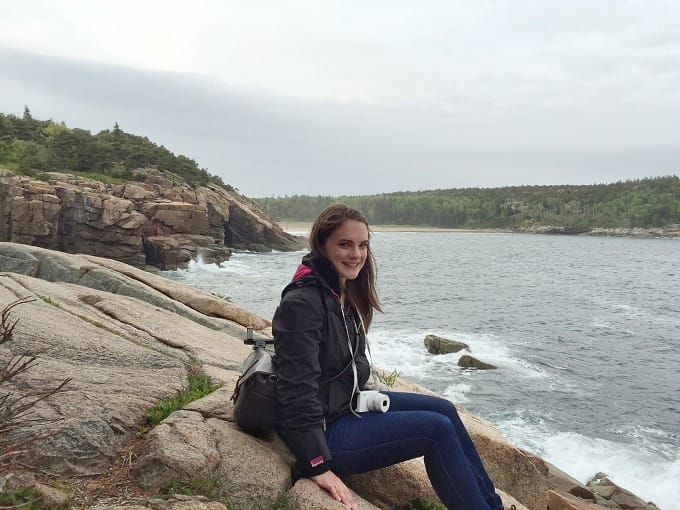 Sitting at the edge of the cliffs in Acadia National Park